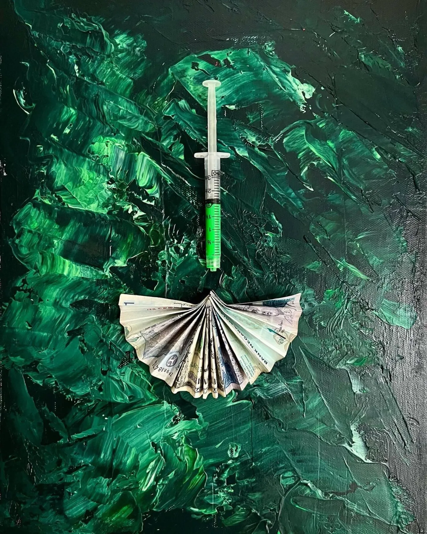A dark green, heavily brushed canvas with a clear plastic syringe hanging point-down above a US dollar bill folded into a fan, the two objects centred like a medical still life.
