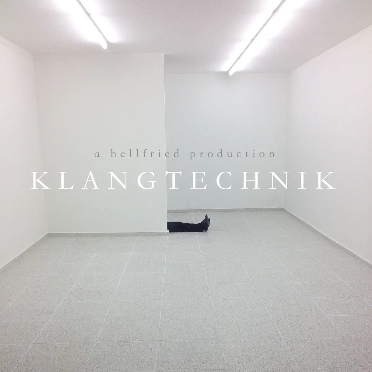 Klangtechnik (2015) original sleeve — a bright, empty white gallery room with a lone figure lying on the floor, the words "a hellfried production" and the KLANGTECHNIK wordmark set in light type across the centre.