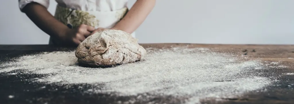 A baker kneading dough